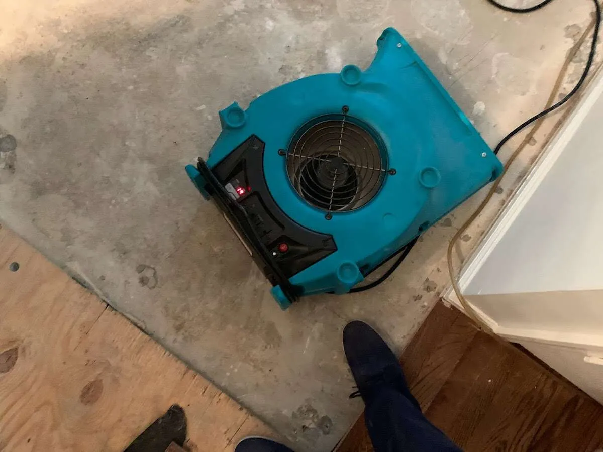 Air mover drying subfloor during Commercial Water Damage Restoration in Rockaway